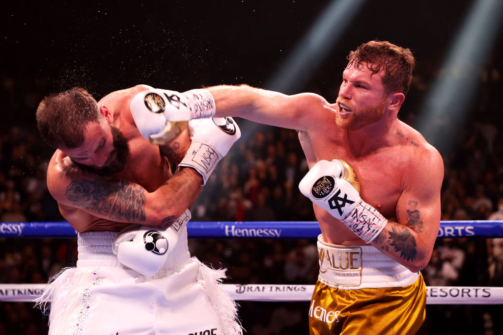 two men are fighting in a boxing ring